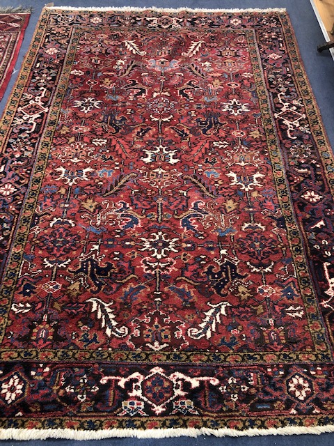 A Persian red ground rug 285 c 190cm